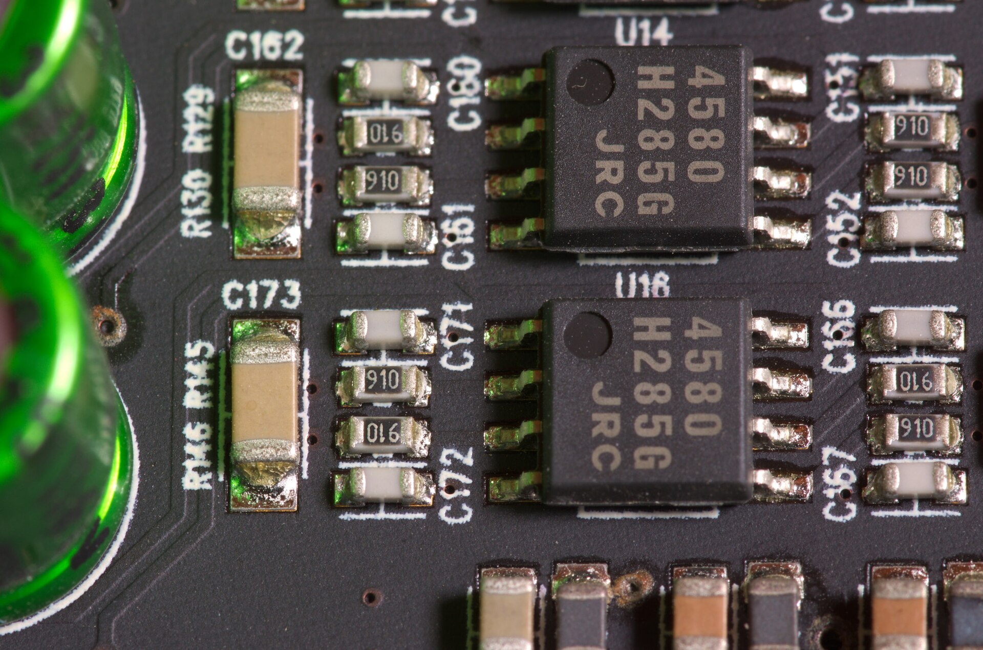 Close-up of populated PCB with electrolytic capacitors and ICs